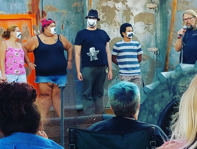 Scix and some haunt actors on stage, practicing mask acting